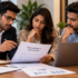 Three startup founders reviewing a shareholders' agreement and corporate documents at a meeting table.